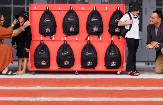 Leesa Haimona, OHS Systems & Assurance Specialist from Kaingaroa Tipu (left) and Whakarewarewa School Principal Boxer Smith with students after receiving their school starter packs.
